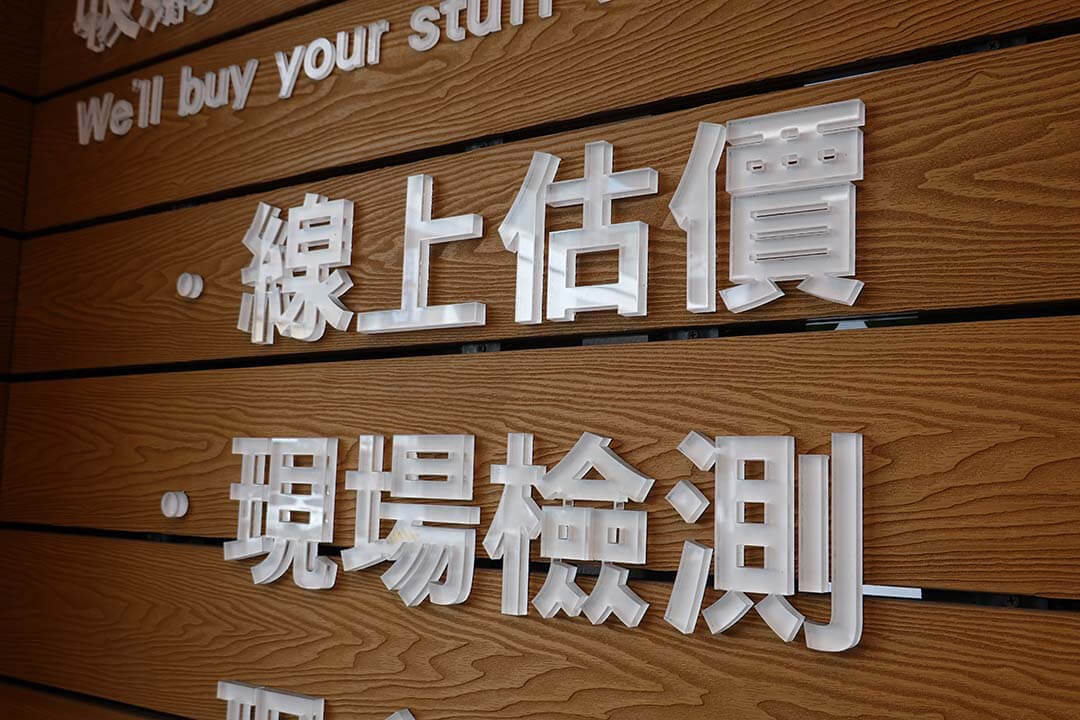青蘋果3C門市木紋牆面，展示「線上估價、現場檢測」字樣服務流程